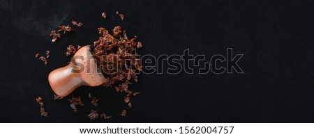 Tobacco and a bowl for a hookah on a black background, shisha fruit arabic for smoking