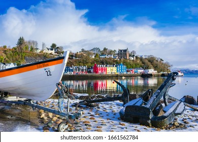 Tobermory, Isle of Mull, Scotland, February 12 2018. Tobermory harbour in Winter with fishing boat, anchor and the famous colourful houses in the background. Wintery scene. Horizontal, space for copy