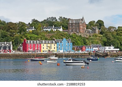 Tobermory, United Kingdom - August 11 2022: pastel colored houses line the harbor in Tobermory on the Isle of Mull in Scotland's Inner Hebrides.