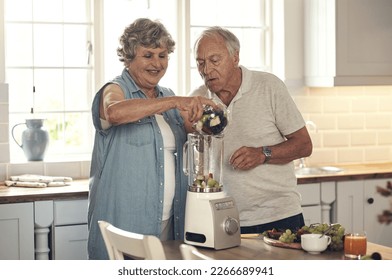 Today were making smoothies. Shot of a senior couple making a smoothie in the kitchen at home. - Powered by Shutterstock