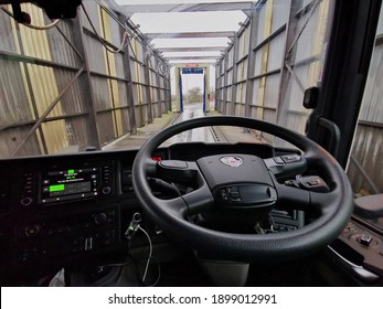 Toddington, Bedfordshire, UK, January 08 2021: Scania Semi Truck Interior Of The Cab Looking Over The Steering Wheel With A View Out T Of The Window Screen Into The The Truckwash 