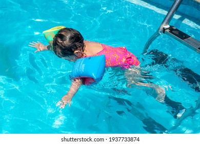 toddler alone diving in the swimming pool