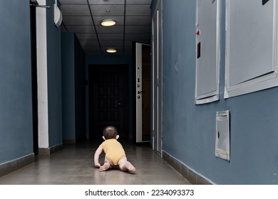 Toddler baby alone in a dark corridor. A lone child boy crawls in the darkness of the hall. Kid age one year - Shutterstock ID 2234093373