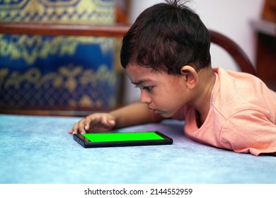 A Toddler Baby Boy Engaged In Watching And Exploring Mobile Phone.Screen Time Addiction Concept Image.