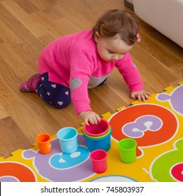 Toddler Baby Girl Plays With Colored Cups, Toy For Cognitive Development.