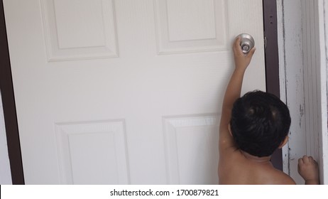 Toddler Baby Hands Kid Reaching Up Try To Open Or Close Door Knob, Child Want To Escape To Play, Explore Outdoor, Security And Safety Concept.