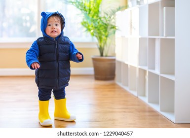 Toddler boy bundled up in winter clothes ready to go outside