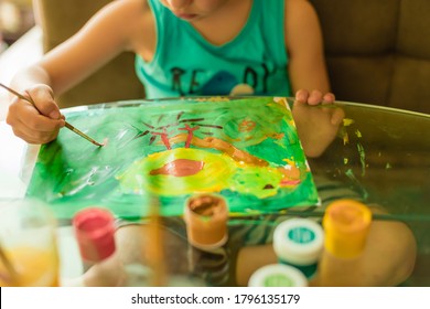 Toddler boy is creativity and the artist in an online drawing paints lesson. Childrens creativity. The concept of distance learning online school for the period of global quarantine.