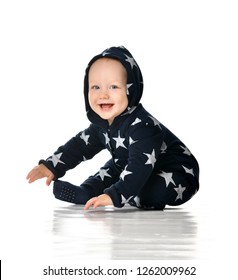 Toddler Boy Dressed In Blue In A Hooded Jumpsuit Sitting Isolated On White Background