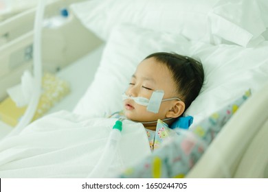 Toddler Boy In Intensive Care Unit Or Icu.Covid19 Coronavirus  Kawasaki Disease.Little Toddler Boy Wearing Oxygen Tube In Hospital.Sick
Patient Child Baby Boy In Icu Bed With Fever In Hospital.