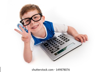 Toddler Boy Lying On The Floor With A Big Calculator And Holding Up Three Fingers.