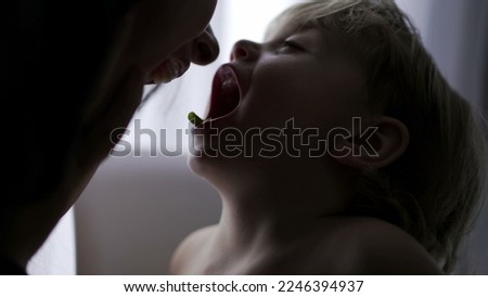 Toddler boy and mother loving relationship kissing and teasing
