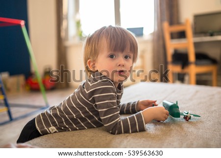 Toddler boy playing with the Airplane, the real interior, soft focus, light toning, concept and childhood dreams