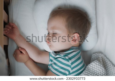 Toddler boy sleeping close-up on bed. Health care concept