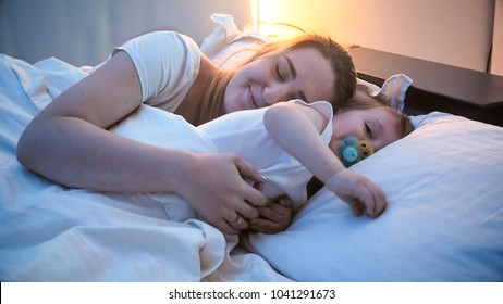 Toddler Boy Sleeping With Mother In Bed At Night