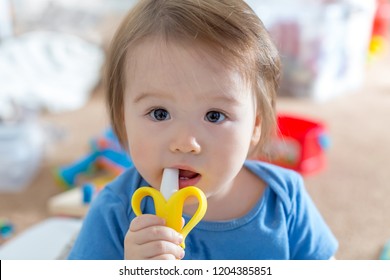 Toddler Boy With A Teething Toy In His House