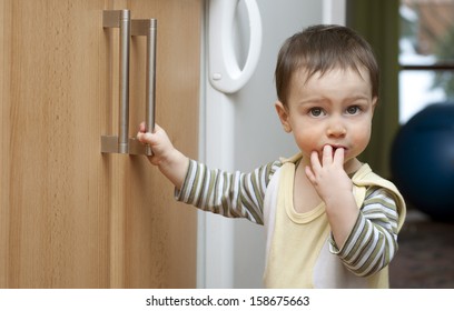 Toddler Child In Kitchen, Children Safety At Home Concept. 