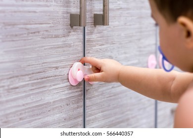 Toddler Child In Kitchen, Children Safety At Home Concept. Unrecognizable