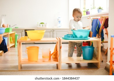 Toddler Child Plays With Water In A Basin, Developing Sensory Activities With Water And Objects, Montessori And Earlier Child Development, Toddler Independence