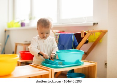 Toddler Child Plays With Water In A Basin, Developing Sensory Activities With Water And Objects, Montessori And Earlier Child Development, Toddler Independence