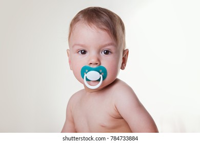 Toddler Close-up With A Pacifier White Background