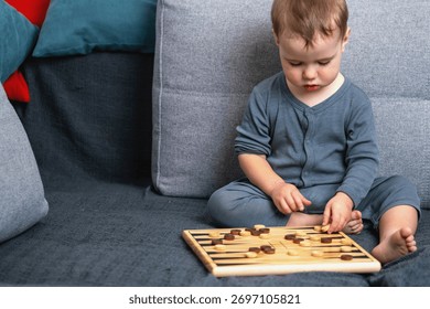 Toddler developing thinking and coordination with board game. Copy space for text or design.