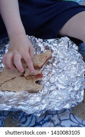 Toddler Eating Peanut Butter And Jelly Sandwich At The Beach                