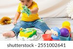 Toddler enjoying a messy cake smash with colorful icing