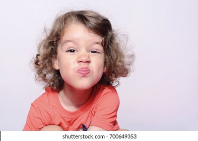 Toddler Expressions, Beautiful Boy Emotions, Kid Having Fun, Boy's Kiss. Kid Making Funny Faces. Boy With Long Curly Hair.