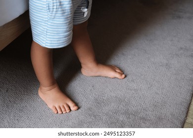 Toddler feet barefoot on the carpet - Powered by Shutterstock