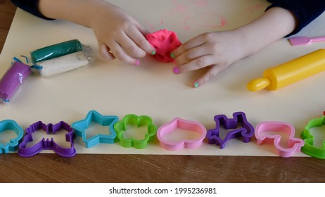 Toddler Forming And Shaping Pink Plasticine Or Clay By Hands And With Yellow Rolling Pin. Play Dough Mold Set For Enhancing Fine Motor Skills. Kid Education Creativity Using Childs Play Doh