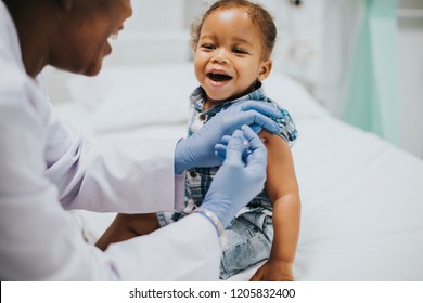 Toddler Getting A Vaccination By A Pediatrician