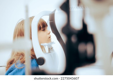 
Toddler Girl During Eye Examination with a Slit Lamp Microscope. Little patient having her retina check with a biomicroscope instrument 
