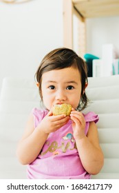 Toddler Girl Eating Banana Muffin