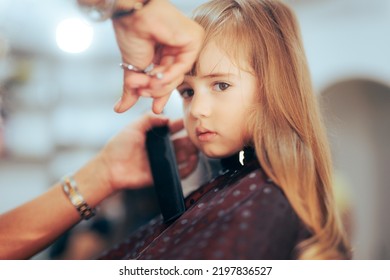 
Toddler Girl Getting Her Bangs Cute In A Professional Salon. Little Preschool Child Having A Haircut In A Beauty Studio
