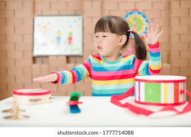 Toddler Girl Play Harmonica At Home For Homeschooling