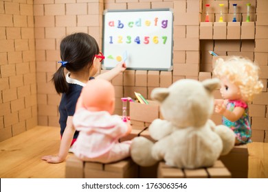 Toddler Girl Pretend Play As A Teacher At Home
