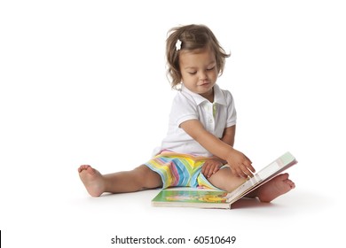  Toddler Girl Pretends To Read A Book Isolated On White Background