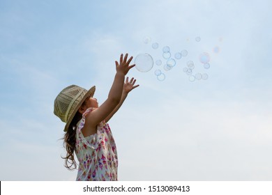 Toddler Girl Reaching For Soap Bubbles