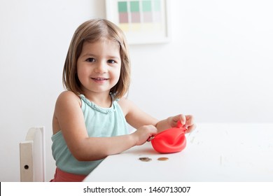 Toddler Girl With Red Wallet,purse Play With Coins.  Financial Support, Business, Family, Alimony, Maintenance, Investing In Children .Learning Financial Responsibility And Planning Savings Concept 