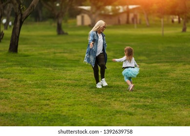 Toddler Girl Running To Her Mother In The Park