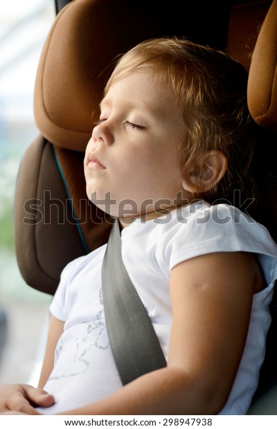 toddler girl is\
sleeping in  the car\
seat