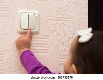 Toddler Girl Turning Off The Light