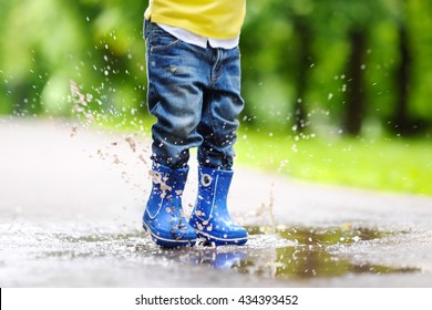 Toddler Jumping In Pool Of Water At The Summer Or Autumn Day
