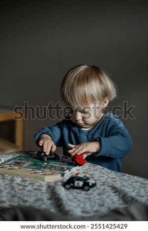 Similar – Baby girl playing with hair clips sitting in the floor