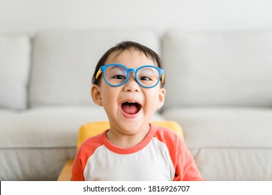 Toddler Kid Boy Wearing Glasses At Home.Asian Toddler Boy Child Make Funny Face.Homeschool Smart Kid Stay At Home In Halloween Holiday.Self Center Child.Emotion, Online Education In Covid19. People.