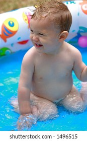 A Toddler In A Kiddie Pool [approx. 18 Mos]