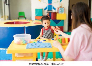 Toddler Learning The Alphabet With A Language Therapist In A Special Education Class