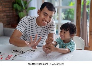 Toddler Learning Math And Counting With Her Father At Home Together