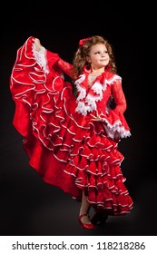 Toddler Little Girl Dancing Flamenco In Traditional Spanish Red Dress. Adorable Child From Andalusia With Curly Hair Dancing Gypsy Dance. Portrait Of Artist Baby In Carnival Bellydancing Costume.